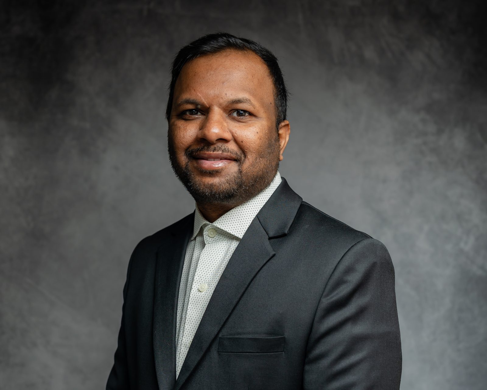 Personal branding headshot, blue backdrop