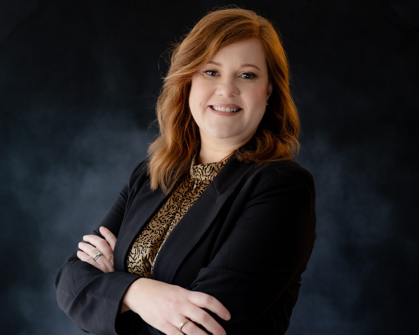 Executive headshot, soft grey backdrop