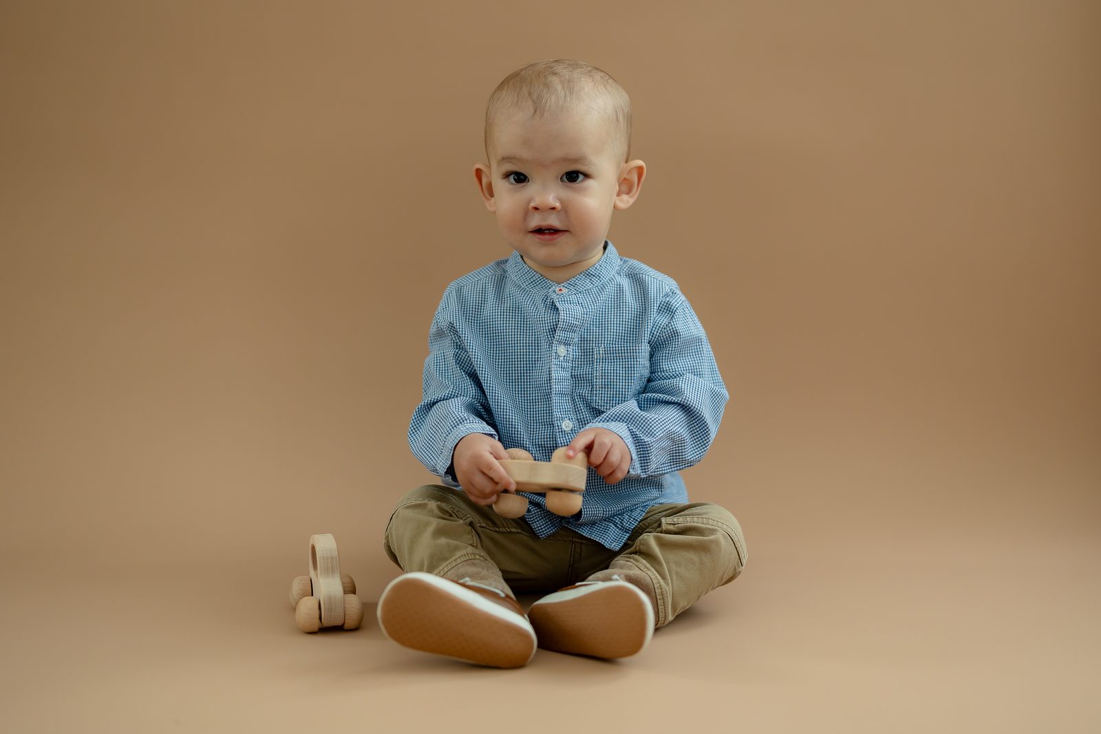 Baby playing with wooden toy car