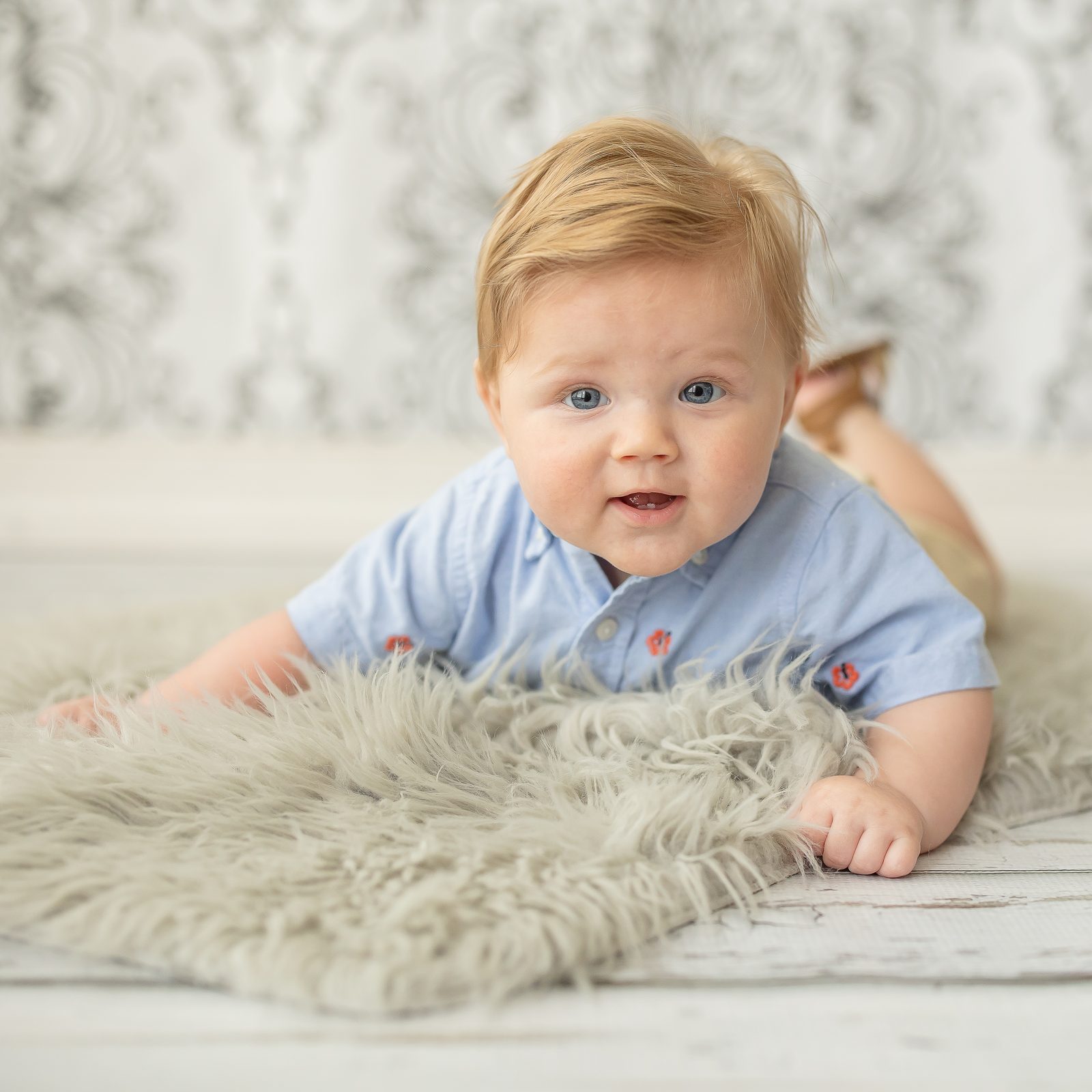Six-month-old smiling on fur rug