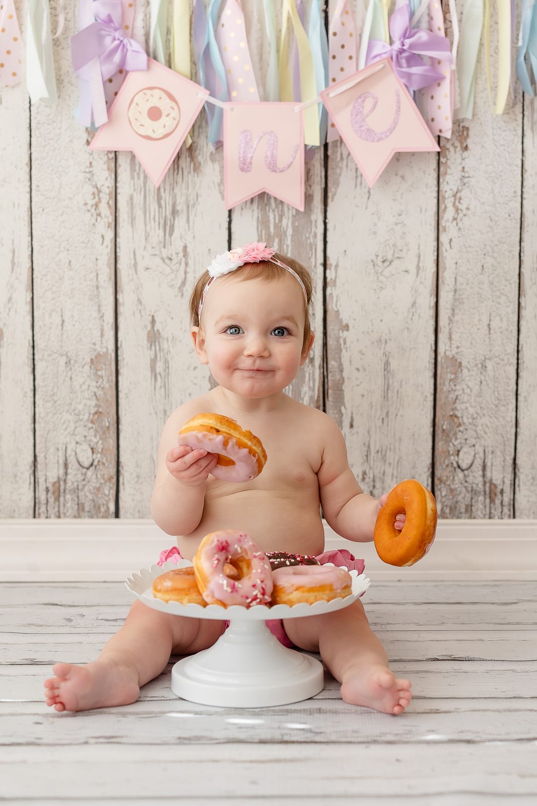 First birthday donut smash with pastel ribbons