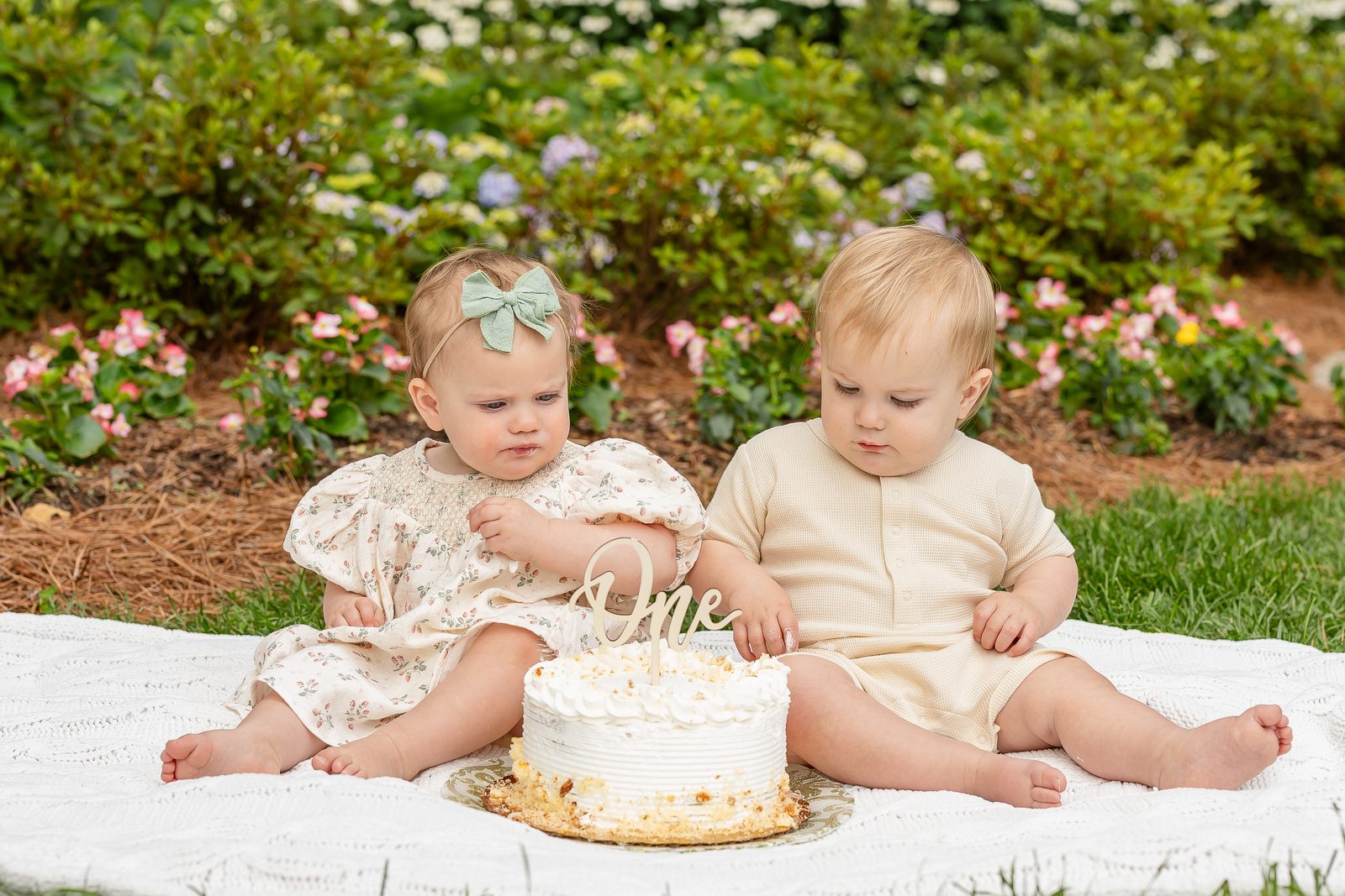 One-year-old twins outdoor cake smash in garden