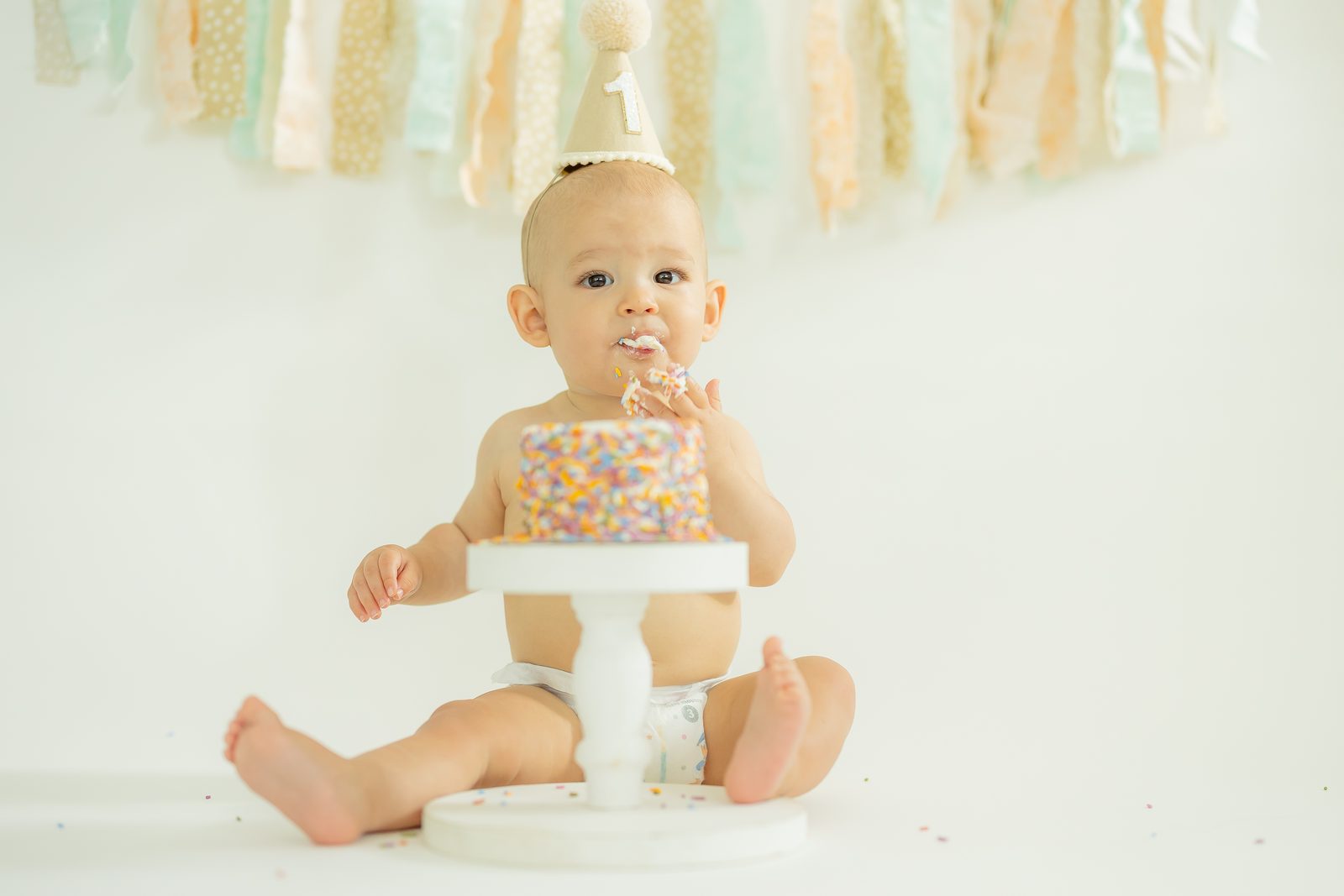 First birthday sprinkle cake with party hat