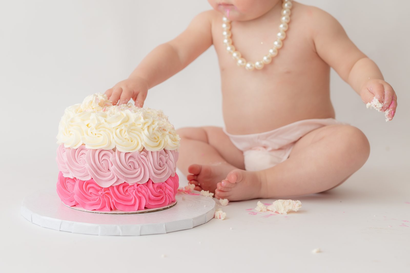 First birthday pink rose cake smash close-up